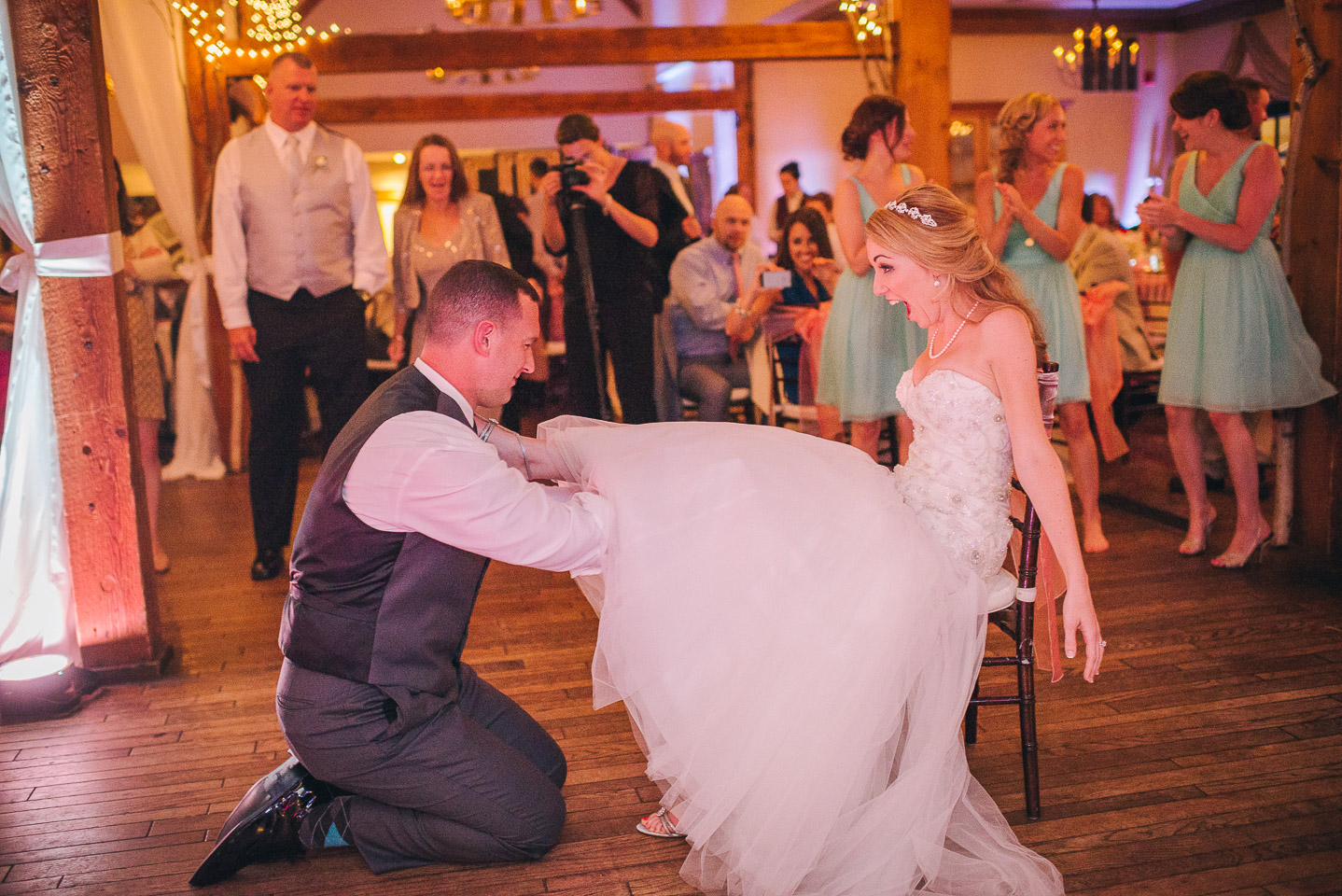 NH Wedding Photographer: groom takes garter