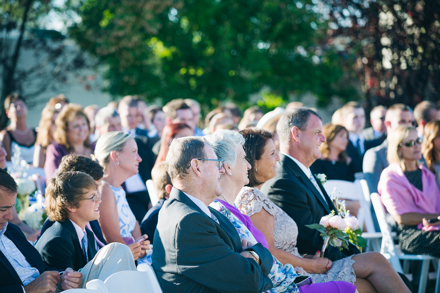 NH Wedding Photographer: guest watching ceremony