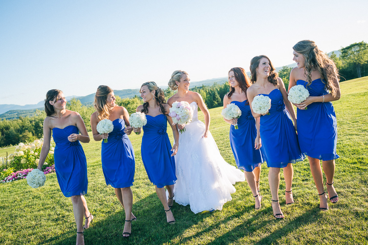 NH Wedding Photographer: bridesmaids with bride walking