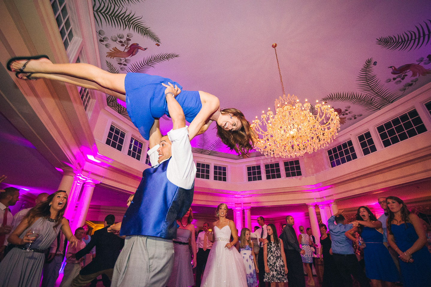NH Wedding Photographer: dancing bridesmaid gets lifted