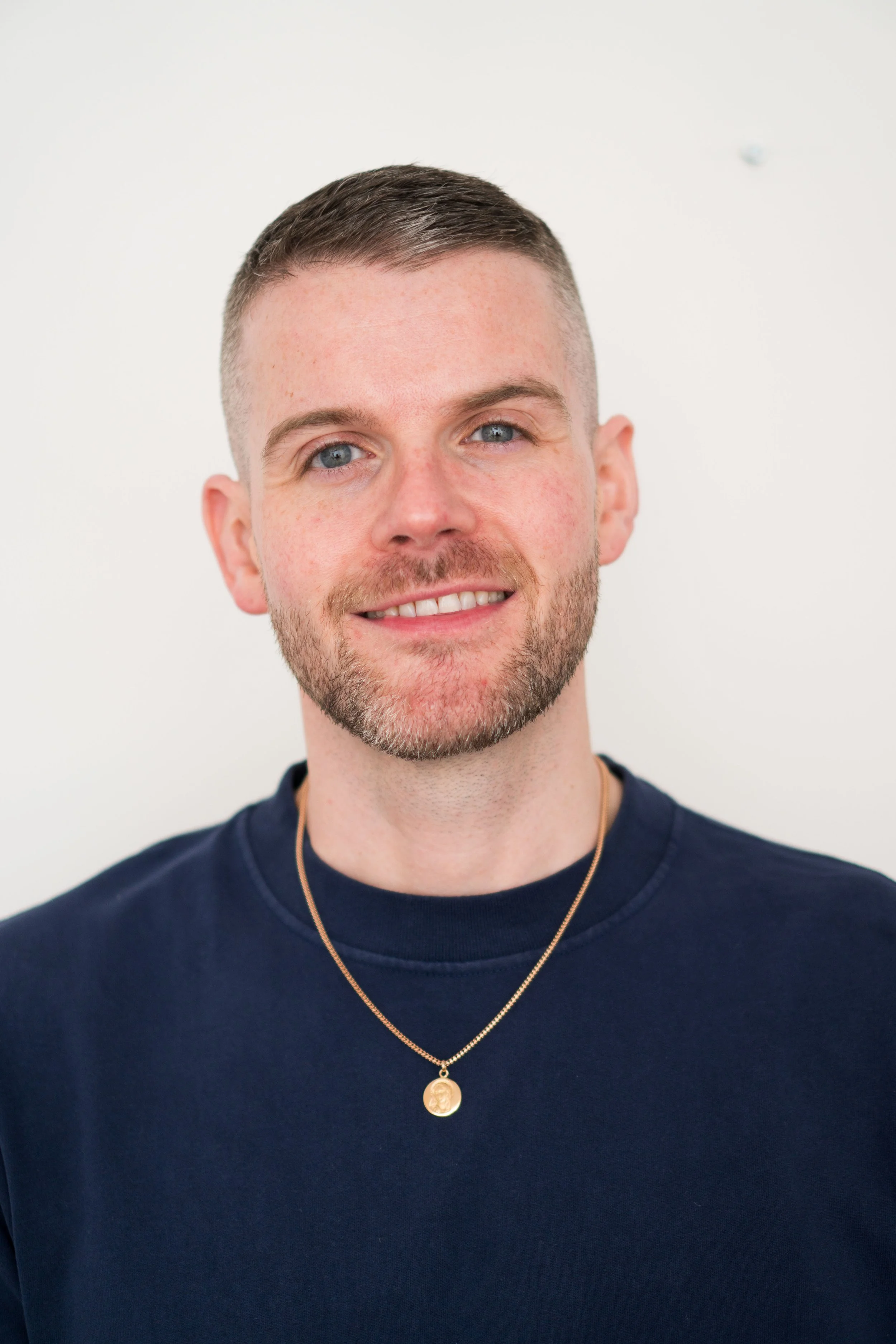 A photographic portrait of Kyle Gray smiling