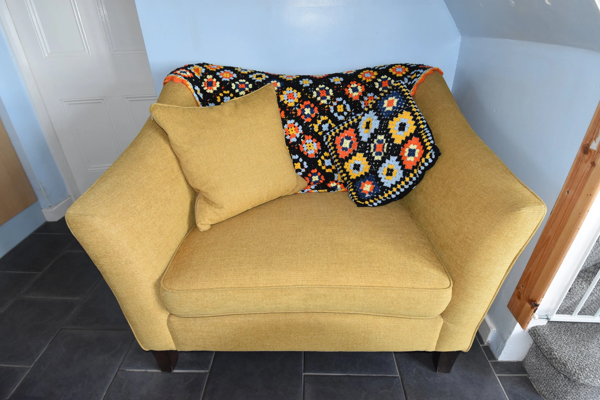 Cuddle up in our kitchen cuddle chair at Sea Glass Cottage.