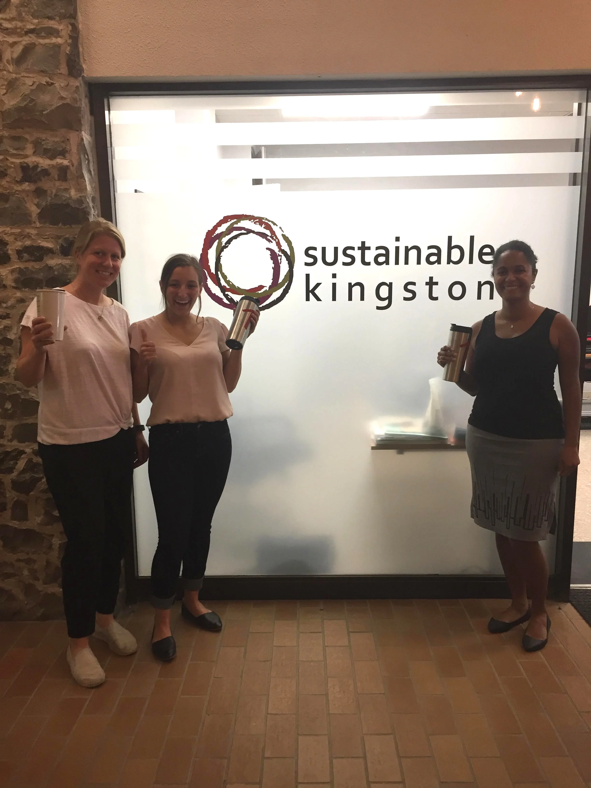 The SK Team with reusable travel mugs