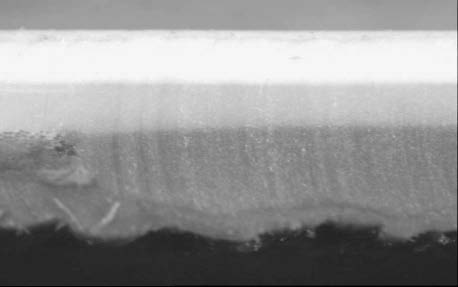 Pictured above is a membrane comprised of an ultra-thin lacquer coating over 13-15 mils of weathering compound over 11-13 mils of a compound that contains less of the weathering ingredients and has a more transparent appearance.