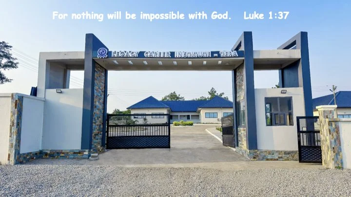 Entrance gate of the Legacy Center Insurers in Teba with a biblical quote from Luke 1:37 at the top. Modern gate structure with blue roofs and a paved driveway.