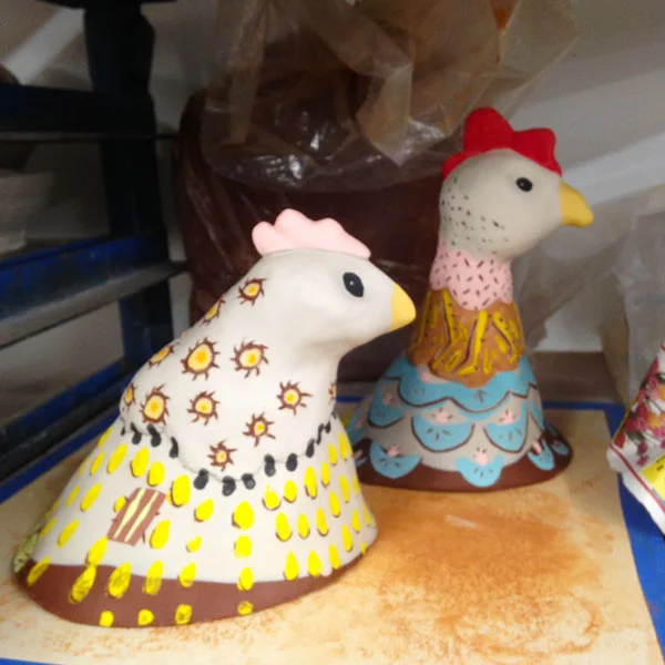 Drying on the shelf, Dot (L) and Jenny (R) after being painted with underglazes. 