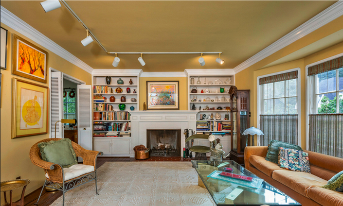 The fireplace and built in shelving make this den one trip to the bookstore short of a study. Also breached through a double collapsing door, the transitions through the rooms are dramatic. The crown molding is the design highlight of the den, remade and repainted over the years.