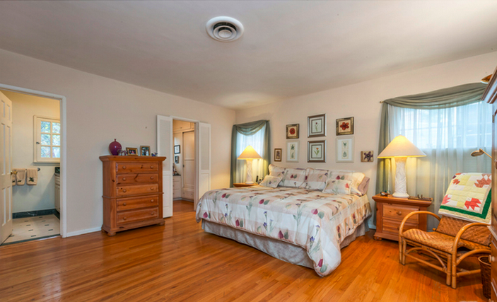 The master bedroom is the largest of the 4 in the house and features original hardwood flooring and an en-suite master bathroom. Its larger than it appears in photos, with room enough for your or your dream life.