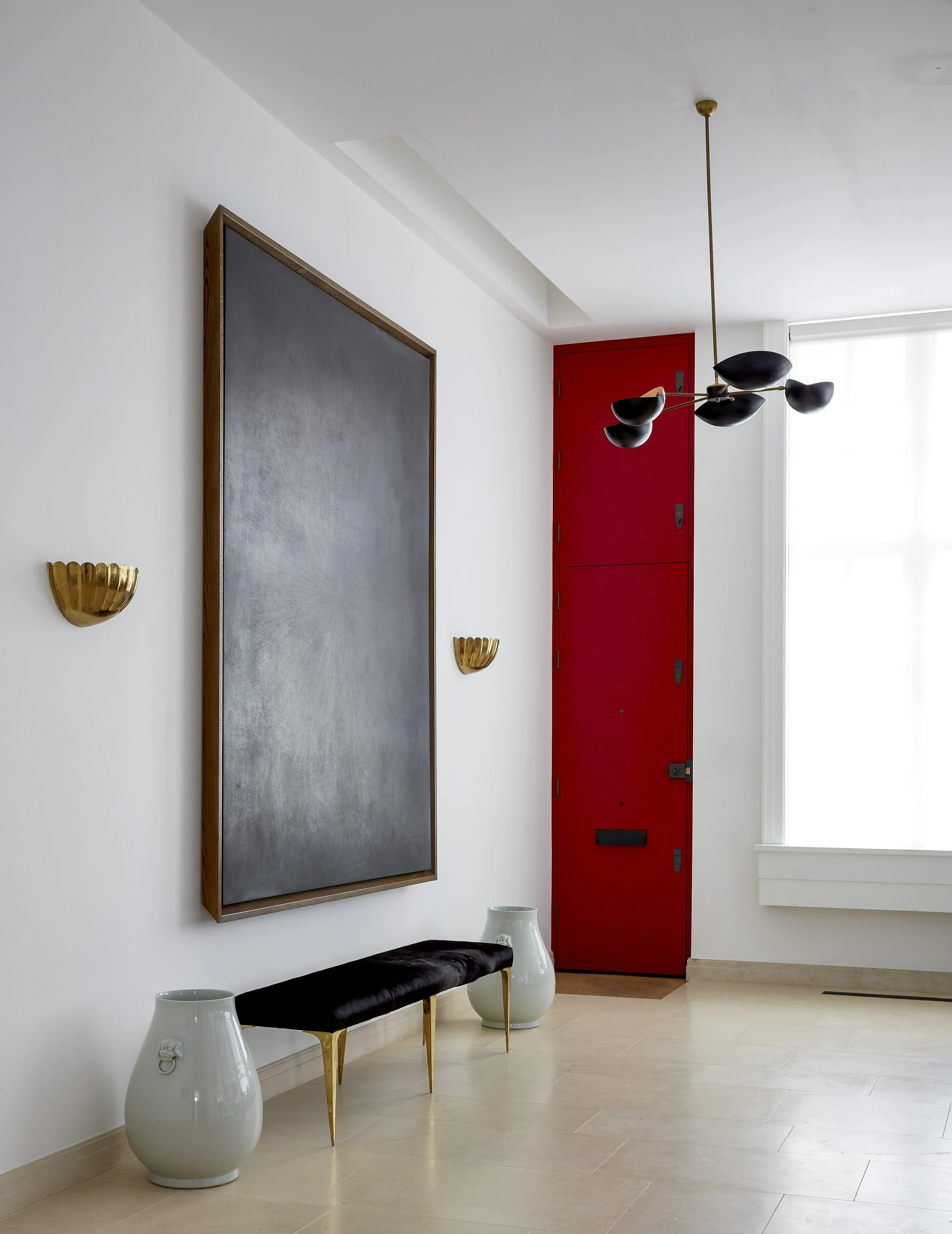 Contemporary hallway with Crittall glass partition bringing light into high-end Chelsea townhouse