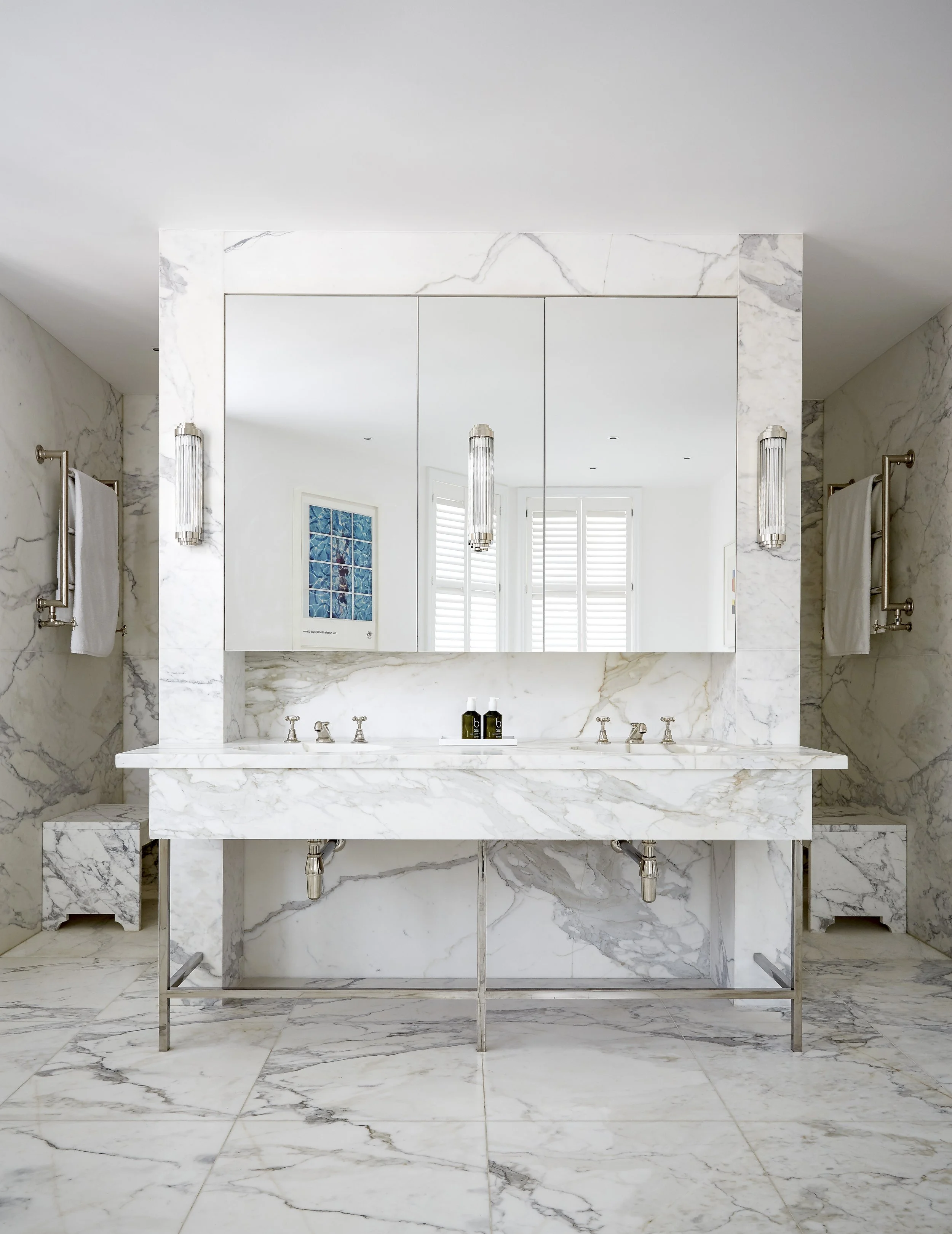 Modern en-suite bathroom with natural stone surfaces in Chelsea mansion renovations