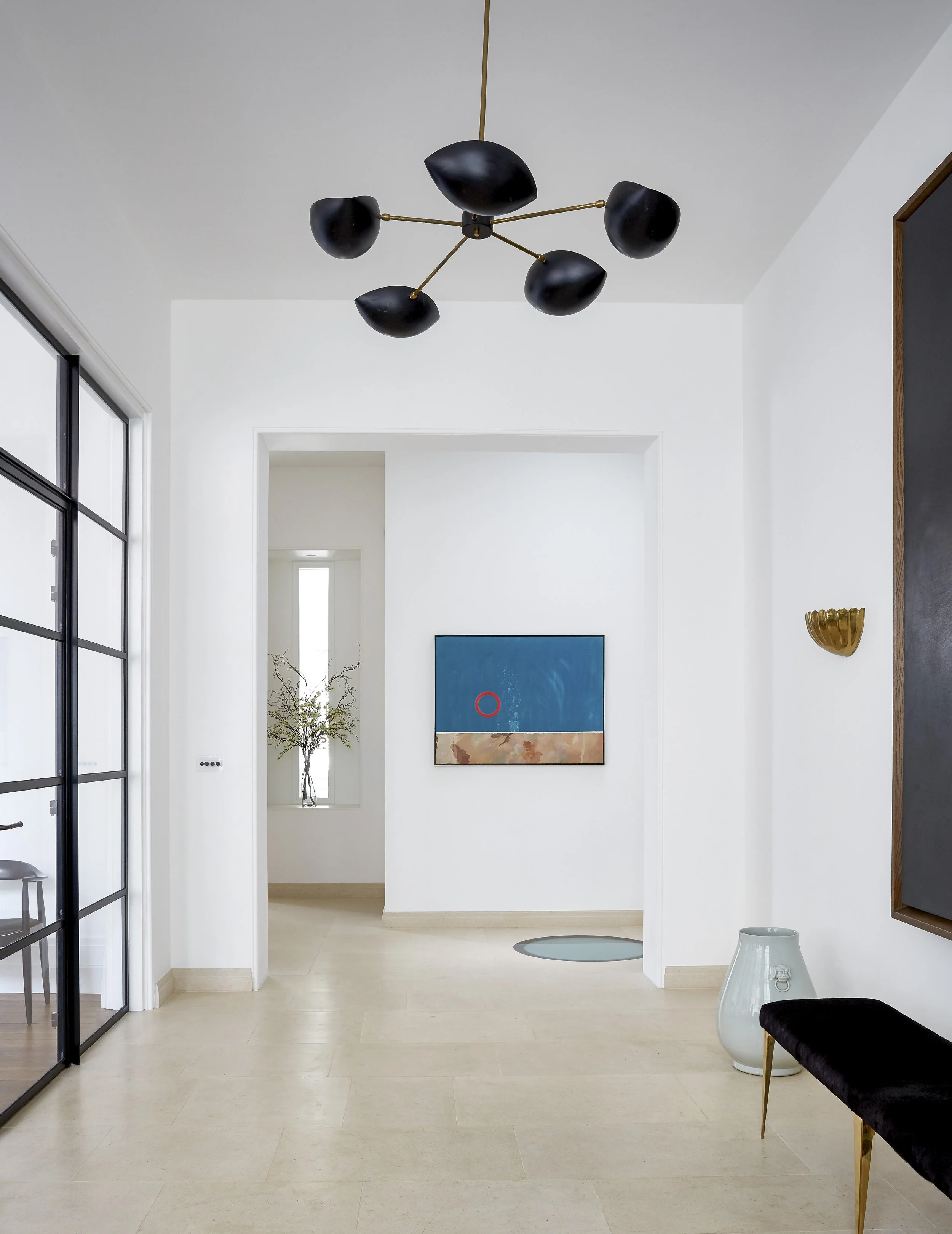 Contemporary hallway with Crittall glass partition bringing light into Chelsea townhouse
