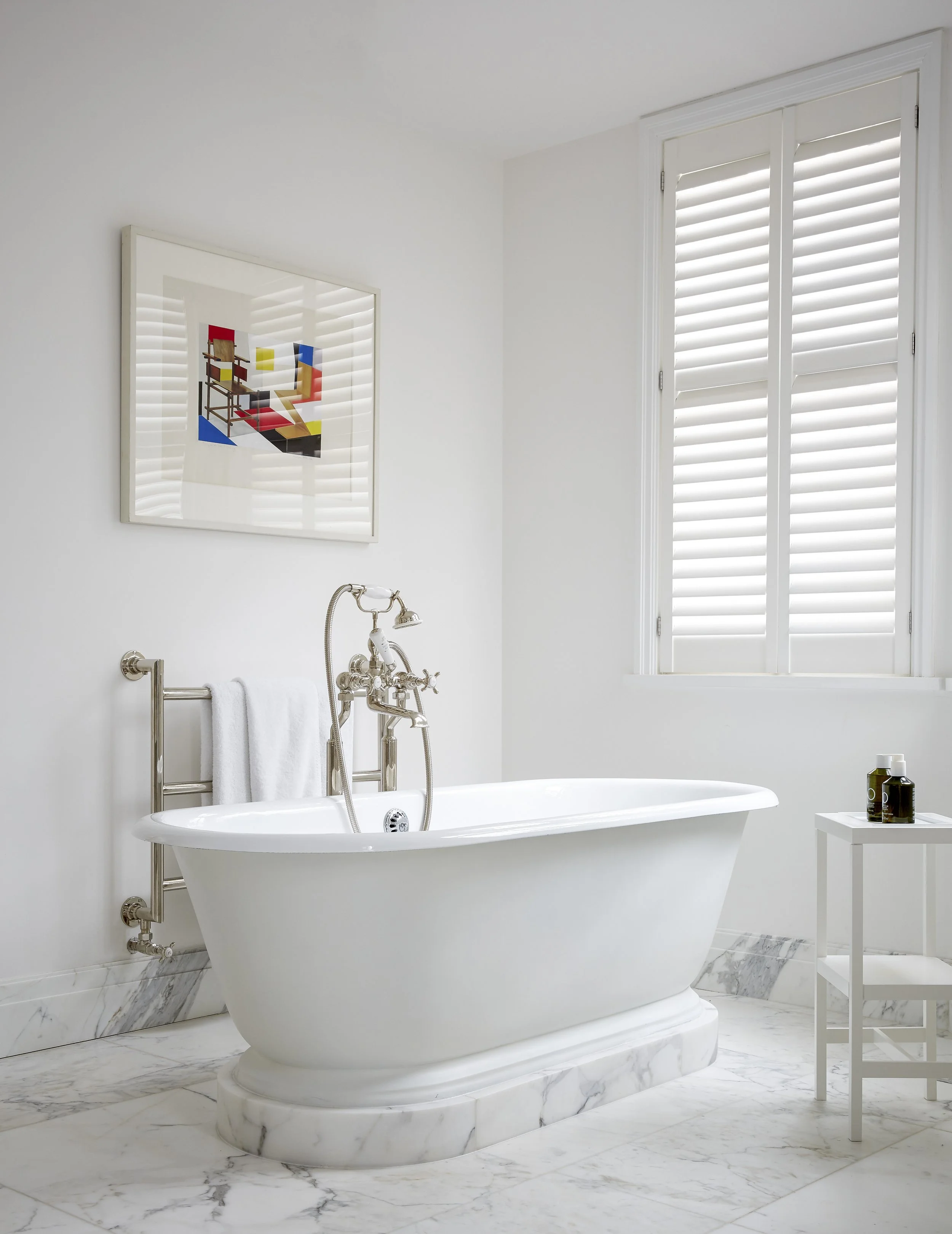 Modern en-suite bathroom with natural stone surfaces in Chelsea mansion renovation