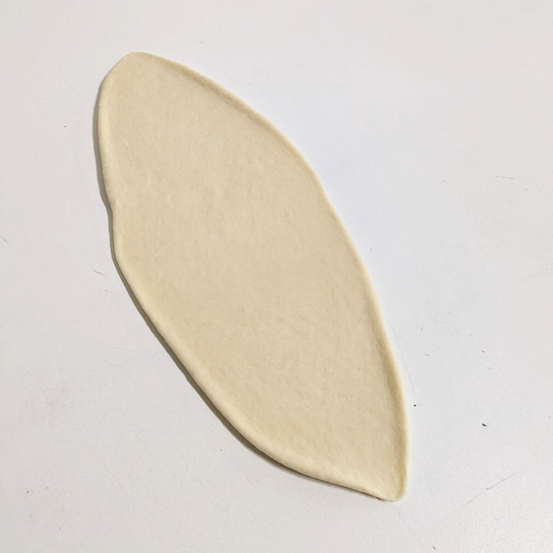 Bagel dough rolled into a long almond shape.png
