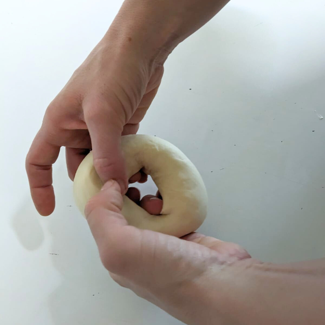 Take the two ends of the filled bagel dough and bring together to make a bagel shape 2.png