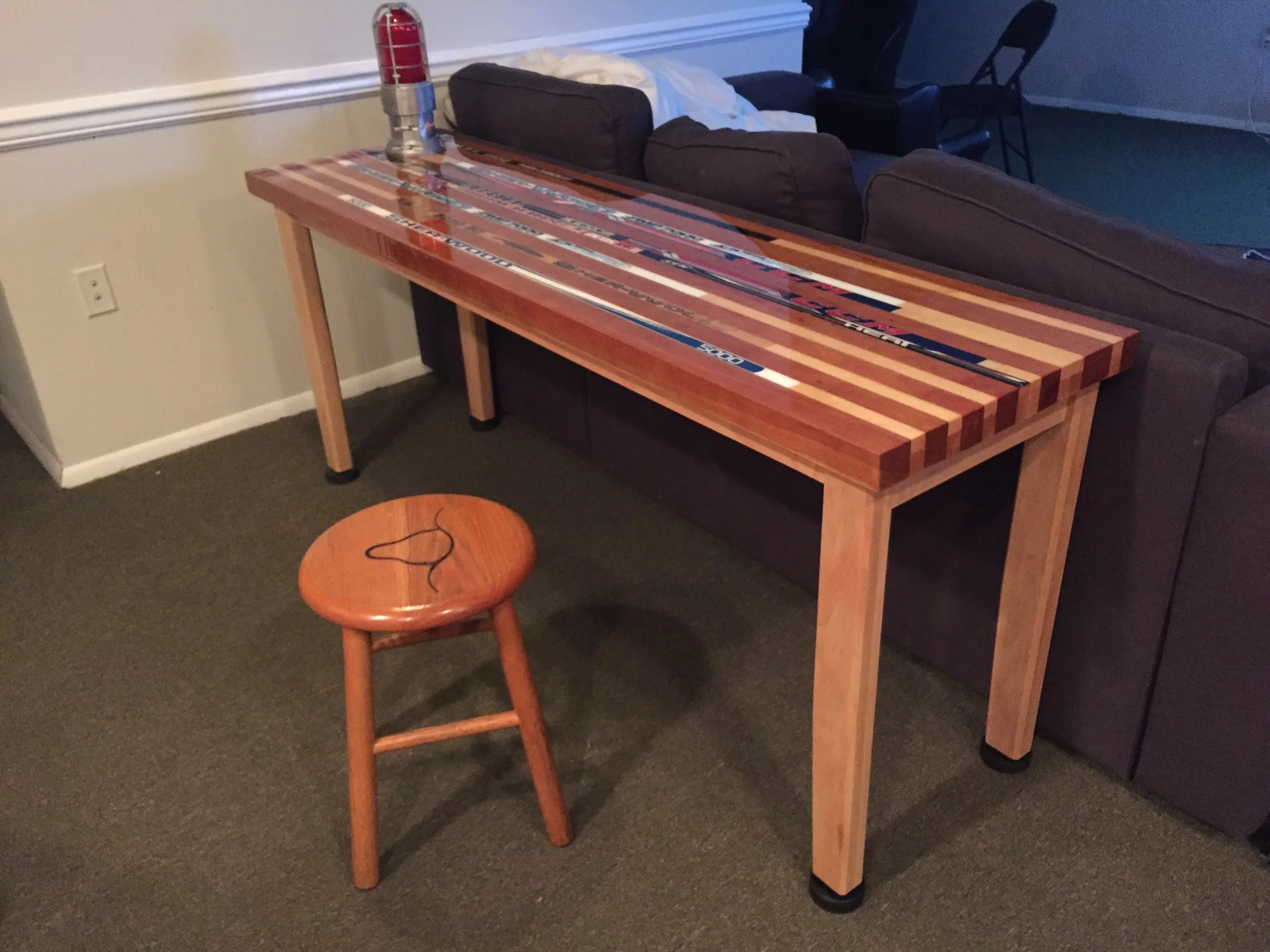  This table was made by sandwiching hockey sticks and hard maple with cherry. &nbsp;The top was coated with a bartop epoxy. 