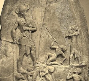 Large figure towering over men on the Victory Stele of Naram-Sin: a metaphorical or literal interpretation?