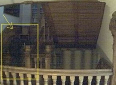 A shadow figure appears to descend the stairs.