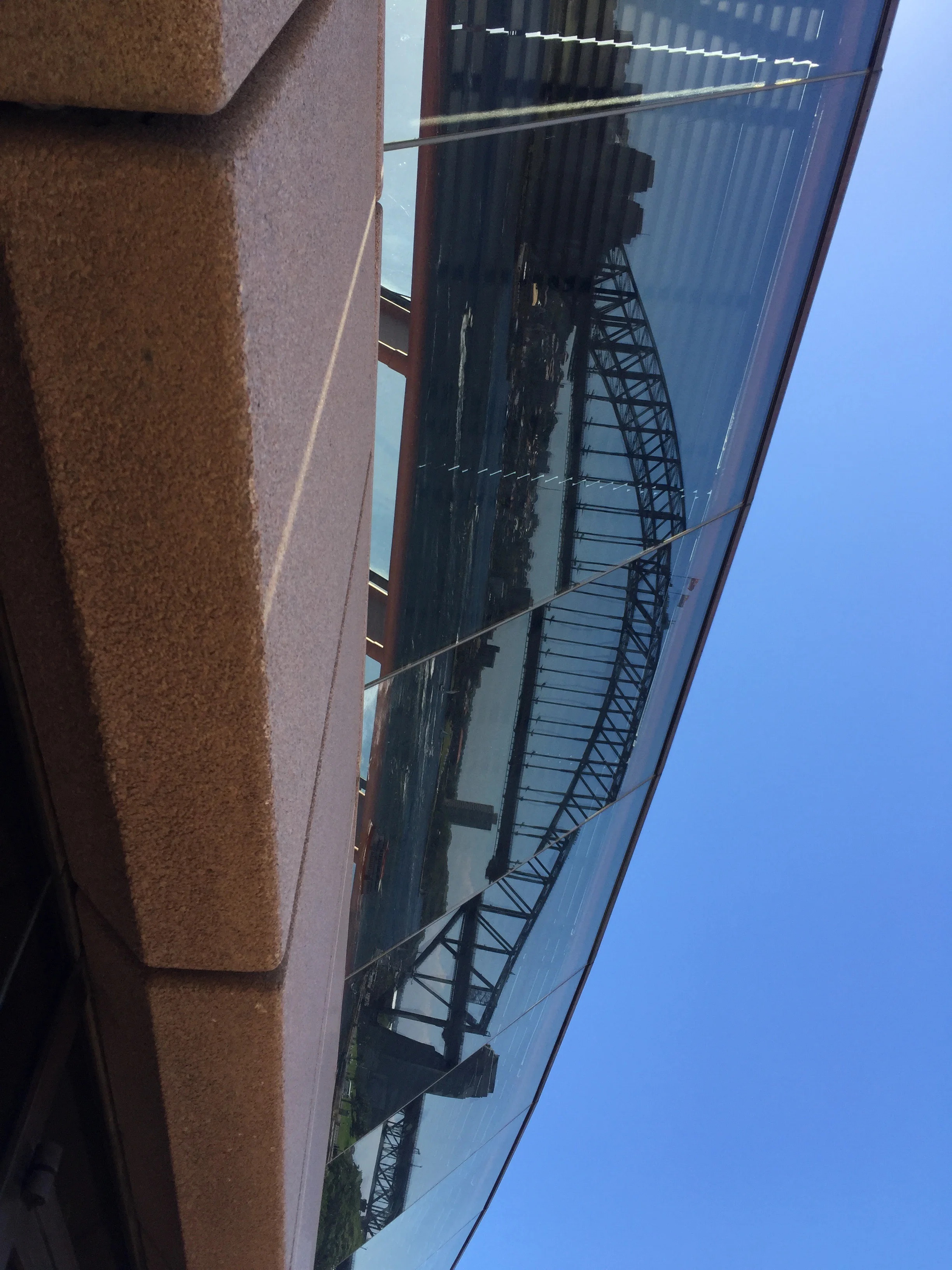 REFLECTION OF THE HARBOUR BRIDGE AT THE OPERA HOUSE