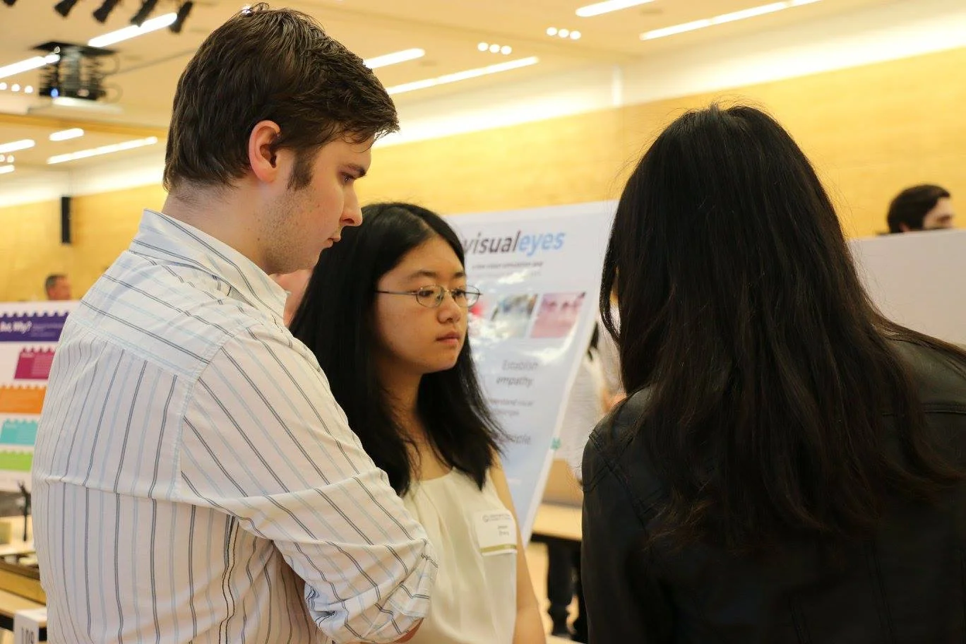 Parker and I discuss the project with an attendee at Capstone Night.