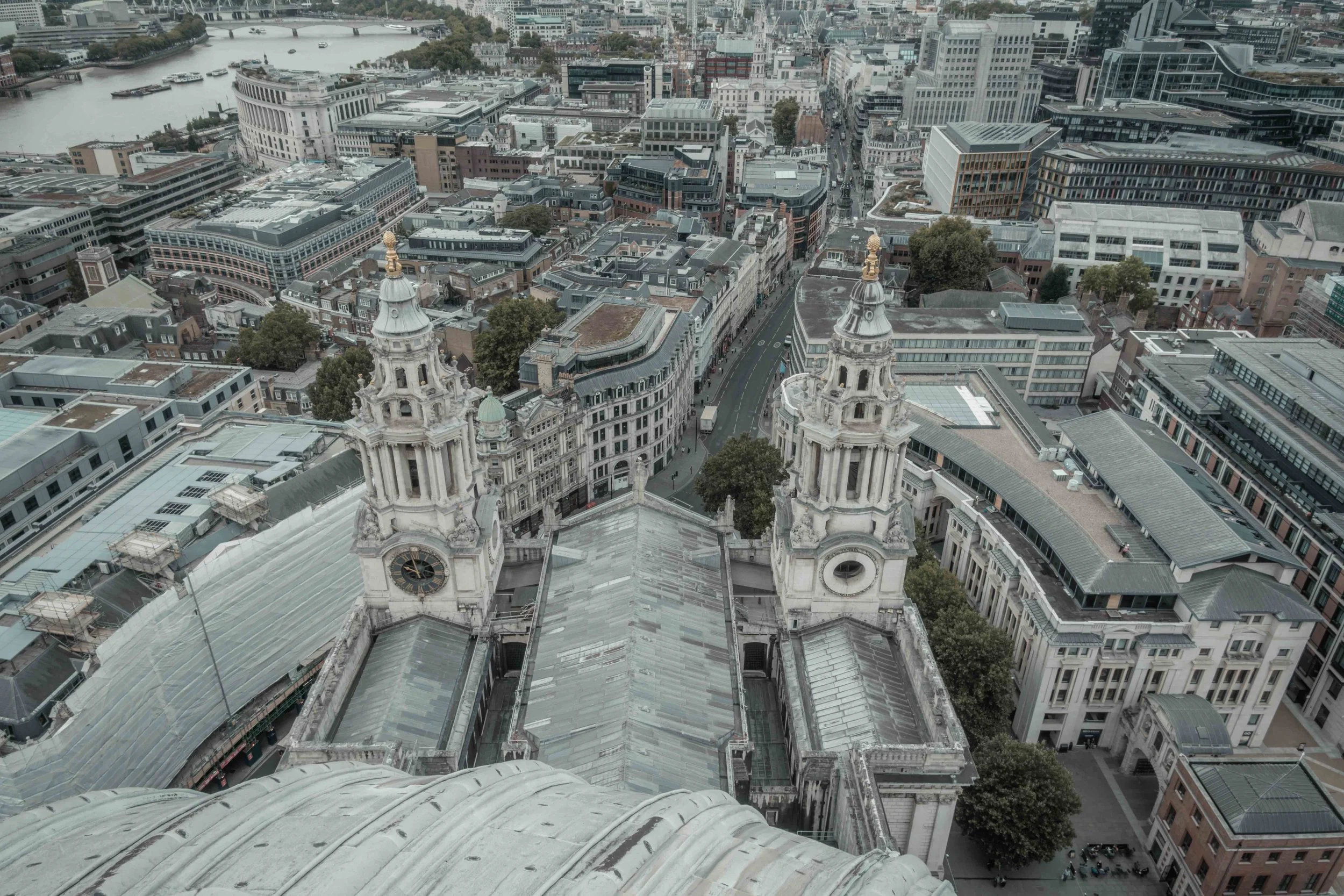 Elevated view from St Paul's Cathedral across its roof and the surrounding City of London towards the River Thames.