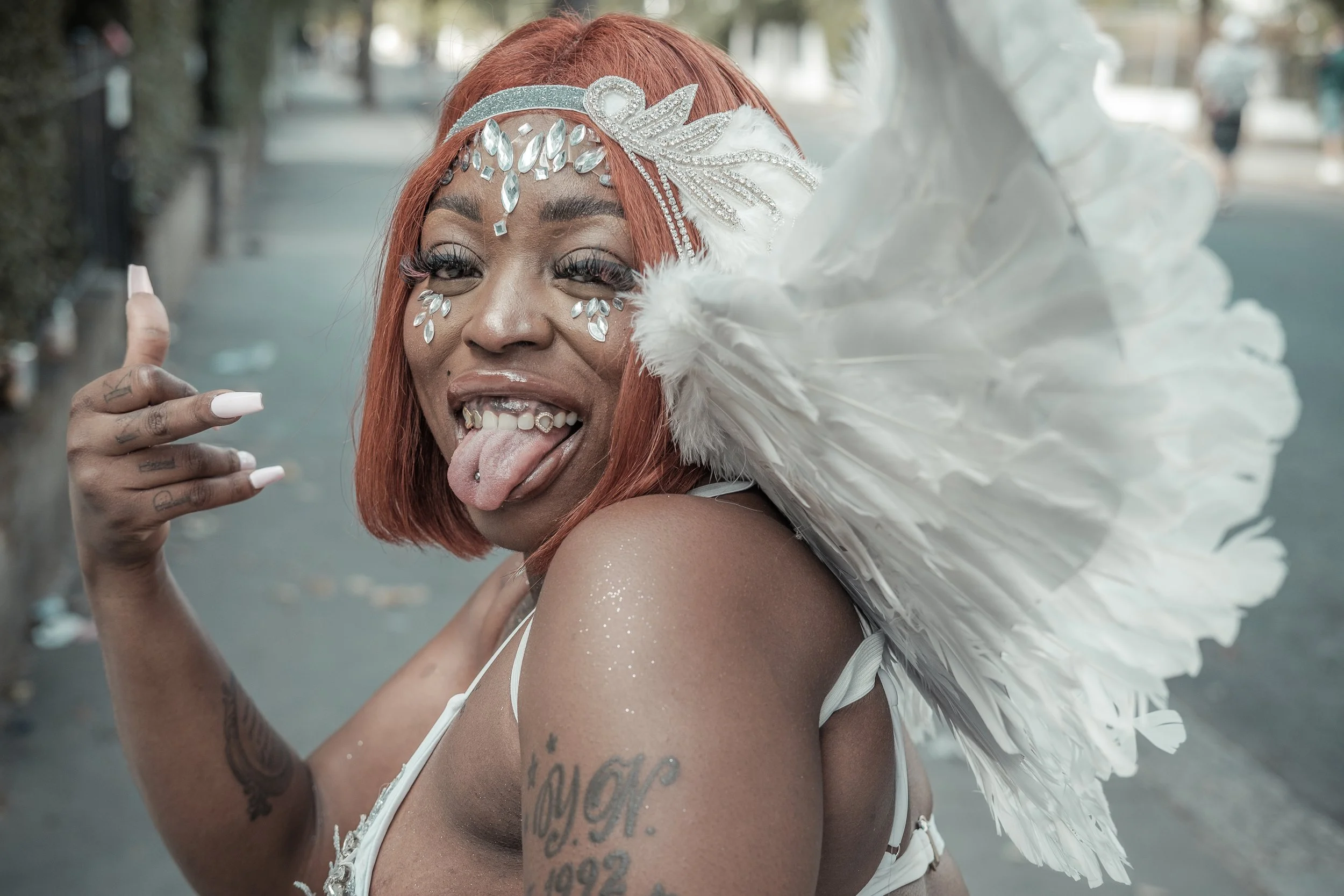 Portrait of a Carnival participant dressed as an angel during Notting Hill Carnival in London, celebrating identity, creativity and Caribbean culture. Photograph by documentary photographer Wayne Crichlow.