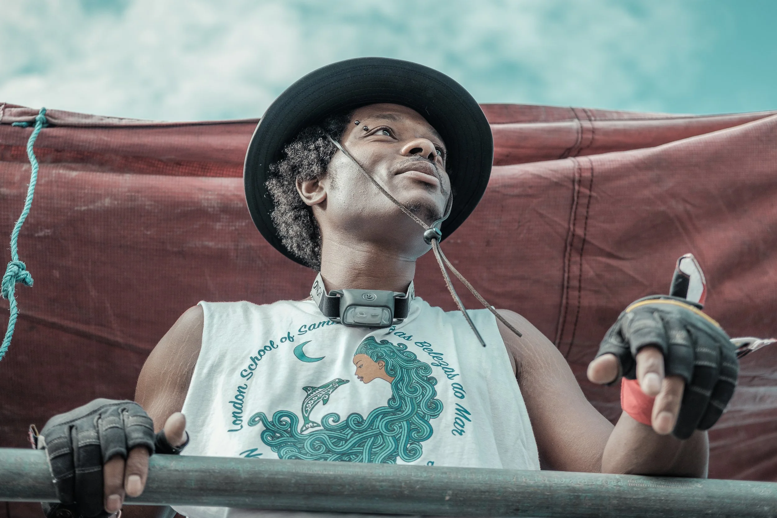 Documentary portrait of a Carnival participant looking towards the sky, celebrating culture, identity and community.