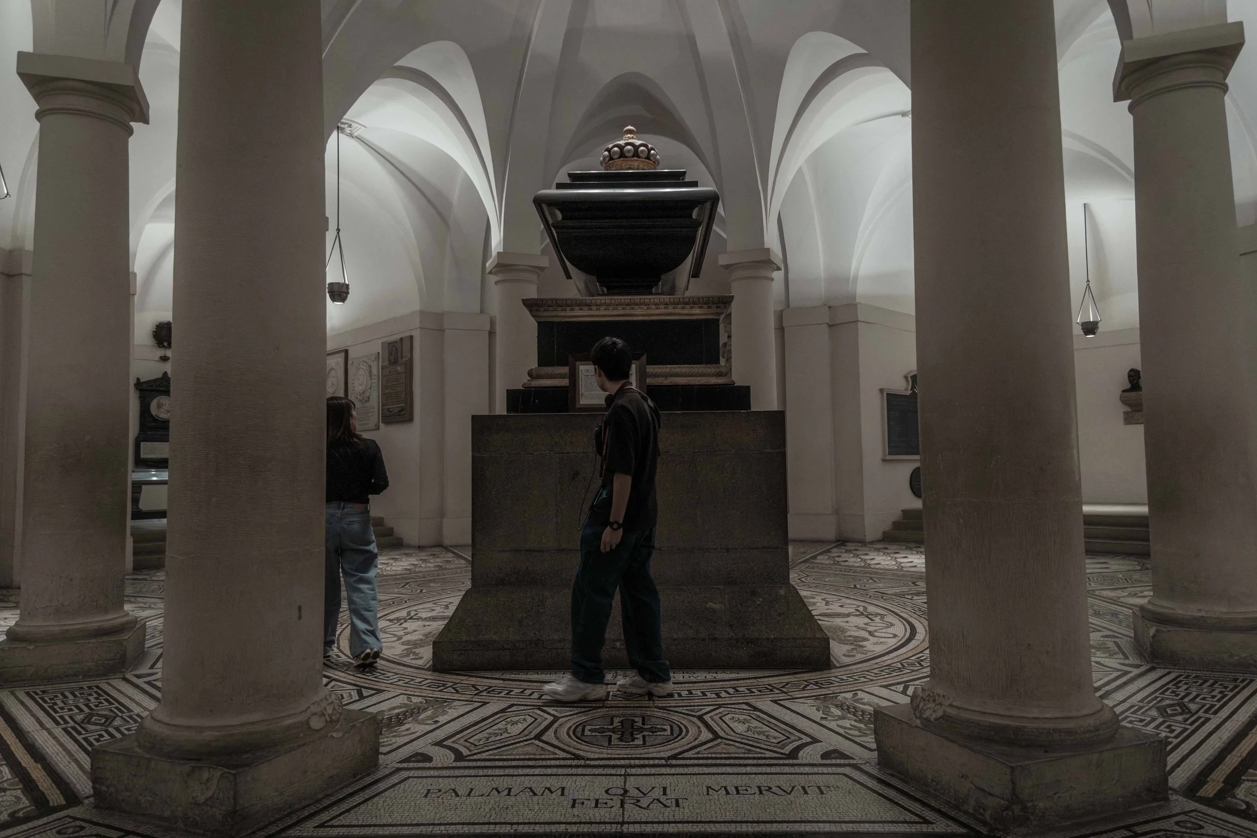 Visitors standing beside the tomb of Admiral Lord Nelson in the crypt of St Paul's Cathedral, London.