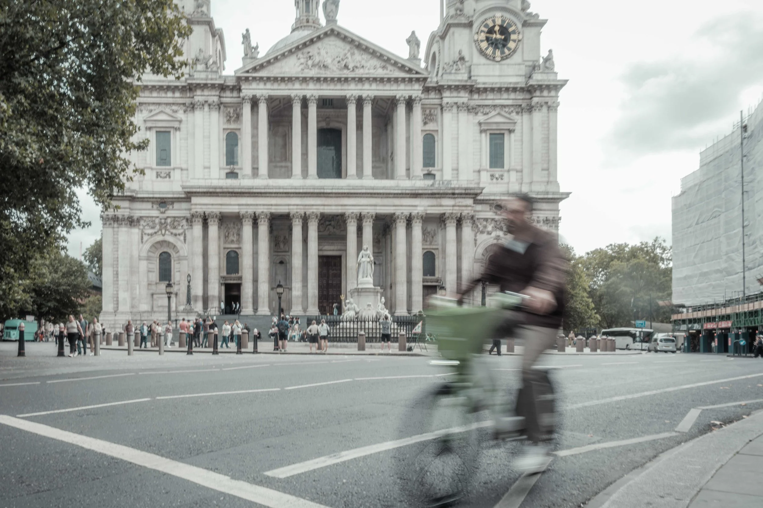 Cyclist passing in front of the grand west entrance of St Paul's Cathedral in central London.