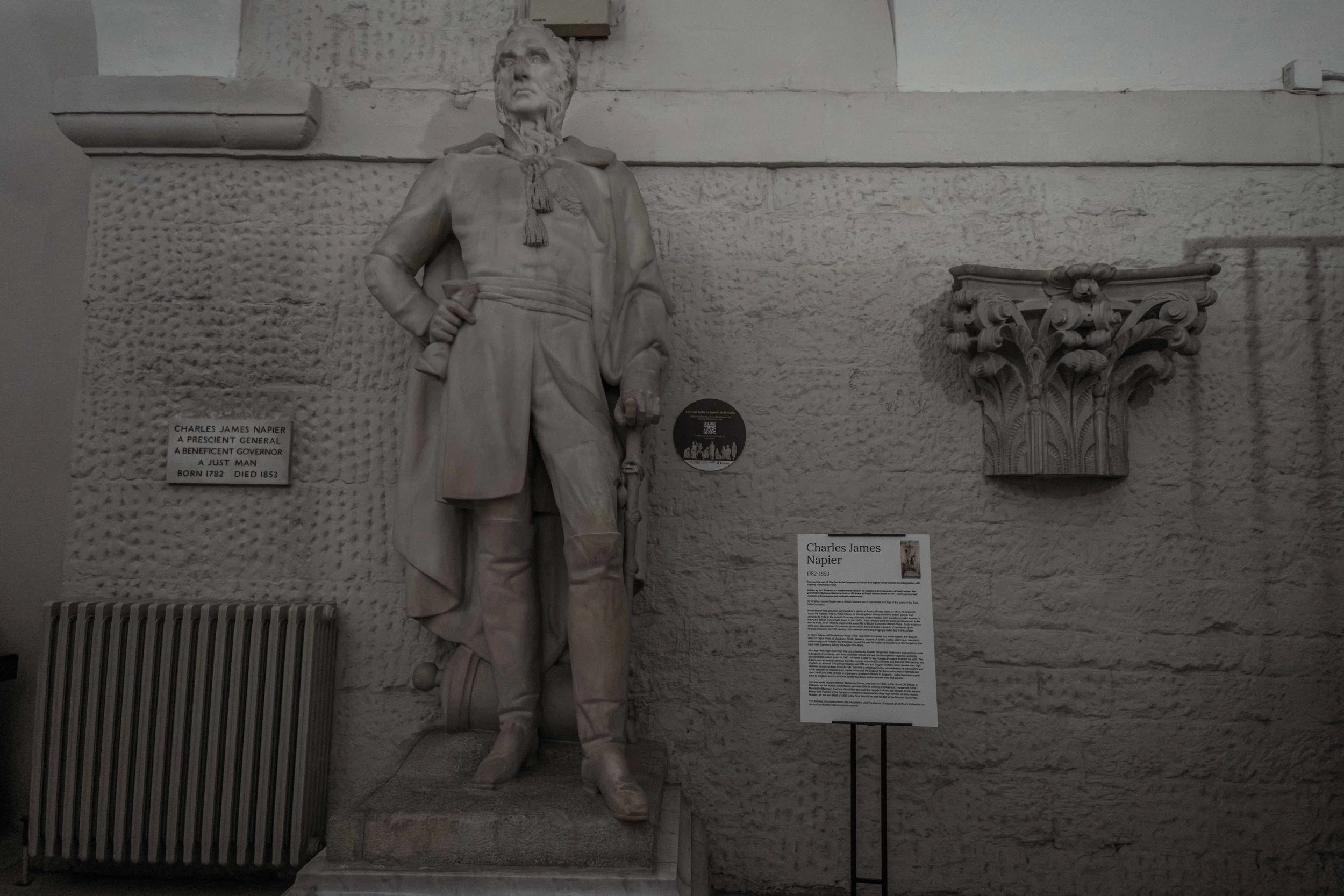 Statue of Charles James Napier inside St Paul's Cathedral, alongside a contemporary visitor information panel.