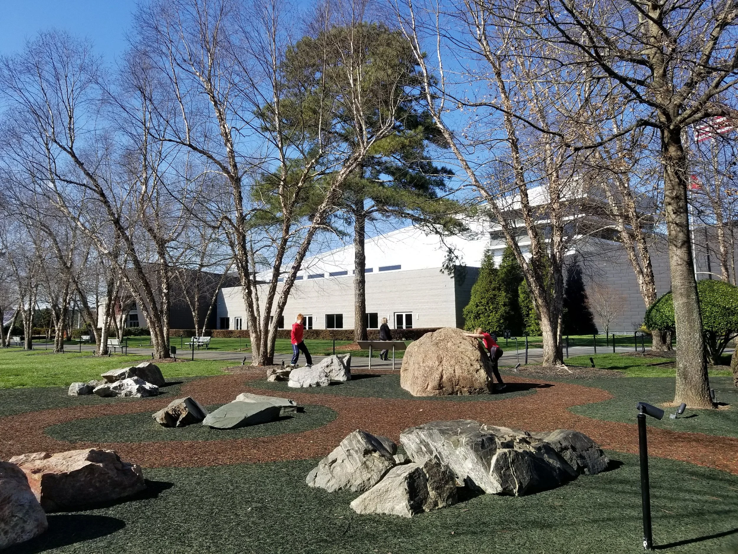 The plaque labels these rocks as sedimentary, igneous, and metamorphic but the boys just had fun climbing on them. 
