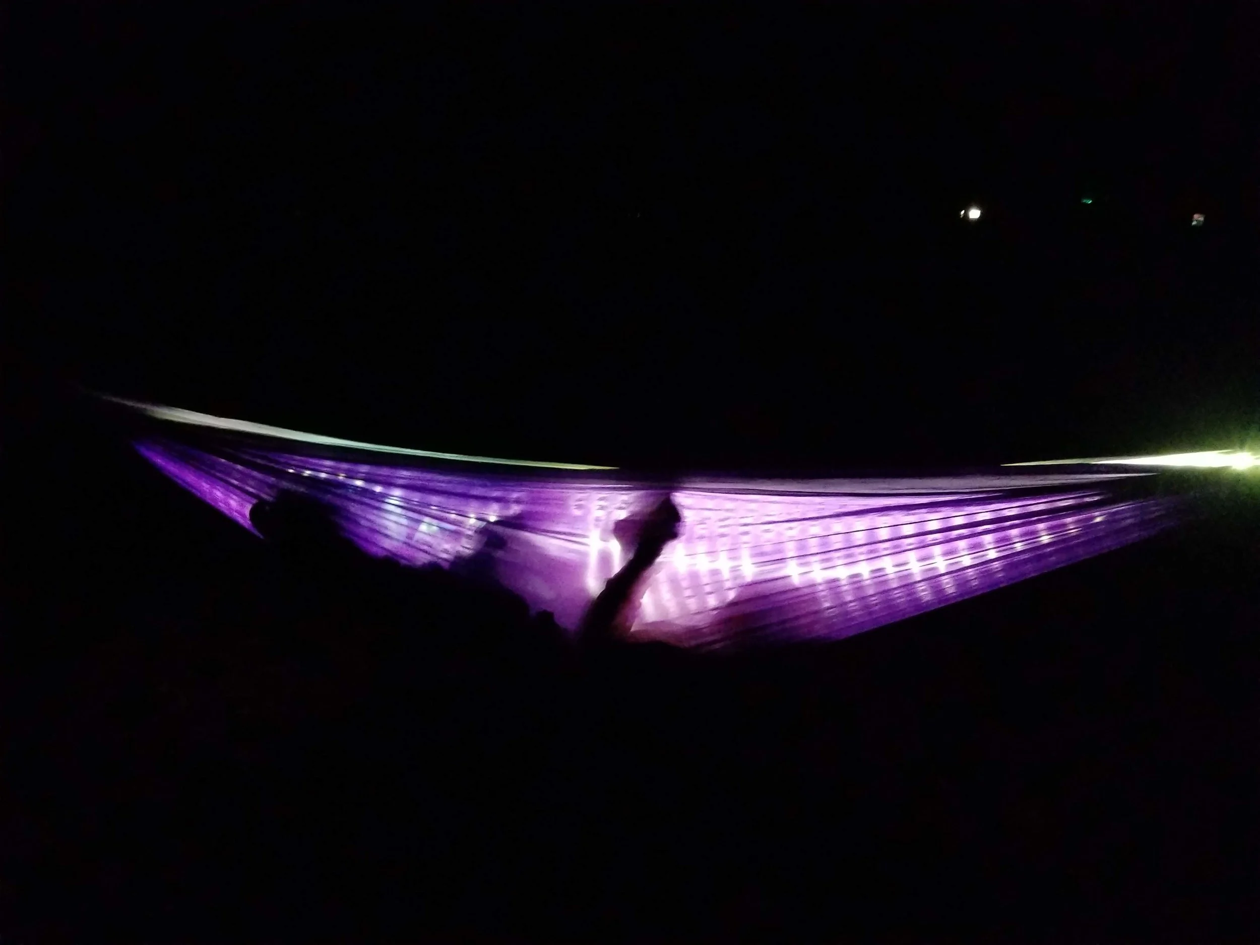 My nephew reading by the light of the Luminoodle in his hammock. It is amazingly bright.