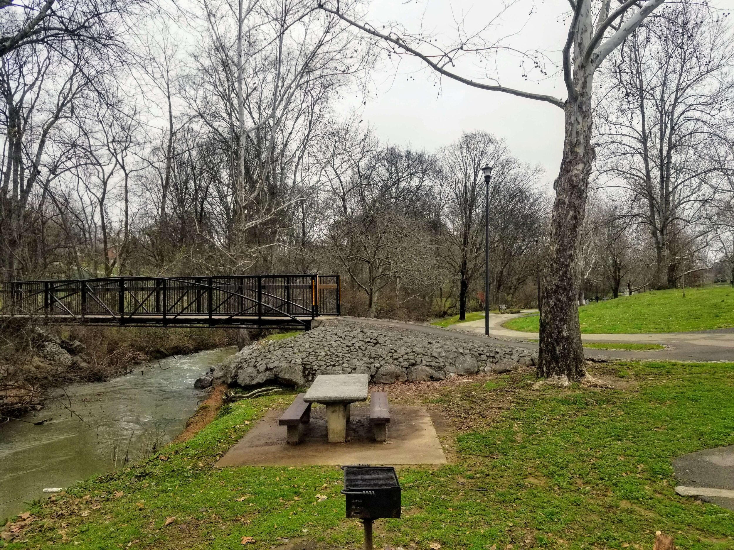 One of the picnic tables by Pistol Creek in Sandy Springs Park