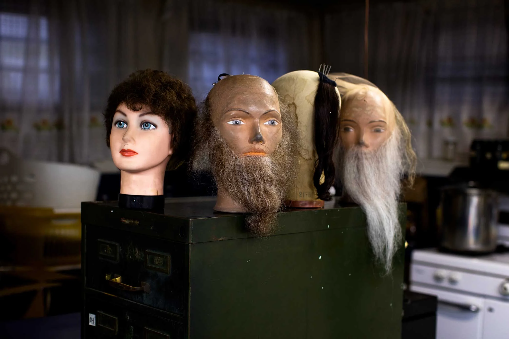  A Collection of head manikins at Claire Grunwald basement Wig Studio in Brooklyn. Claire Grunwald is the owner of Claire Accuhair, a Brooklyn wigs company that for fill customers orders by hand with authentic hair. The Orthodox community make up most of her clientele with orders of wigs and beards. Claire works along side her daughter’s Chanie Handler, 56, Chaya Goldish, 64, and her Husband Moses Grunwald, 90. 