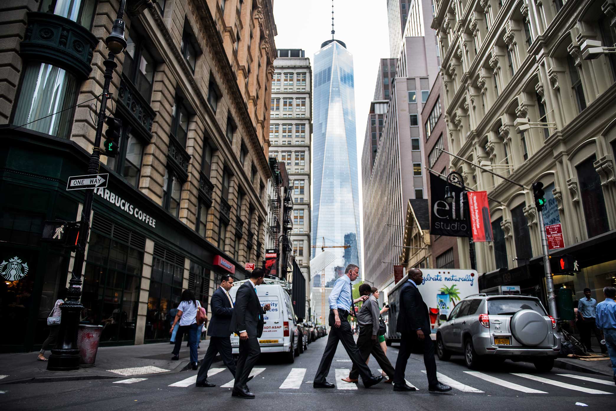  Mayor Bill de Blasio walk past the World Trade Center on his way to City Hall. 