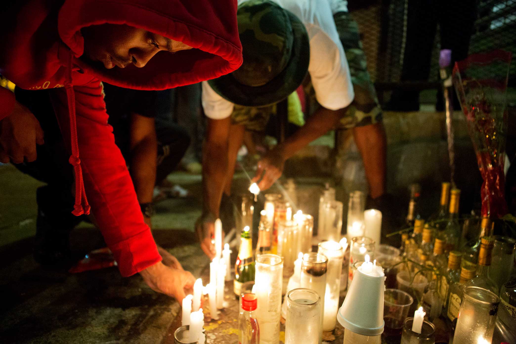 Locals light candles in memory of Olivia Brown a 23 year old who was gunned down at the Lincoln Houses at 60 East 132nd Street Harlem, New York. 