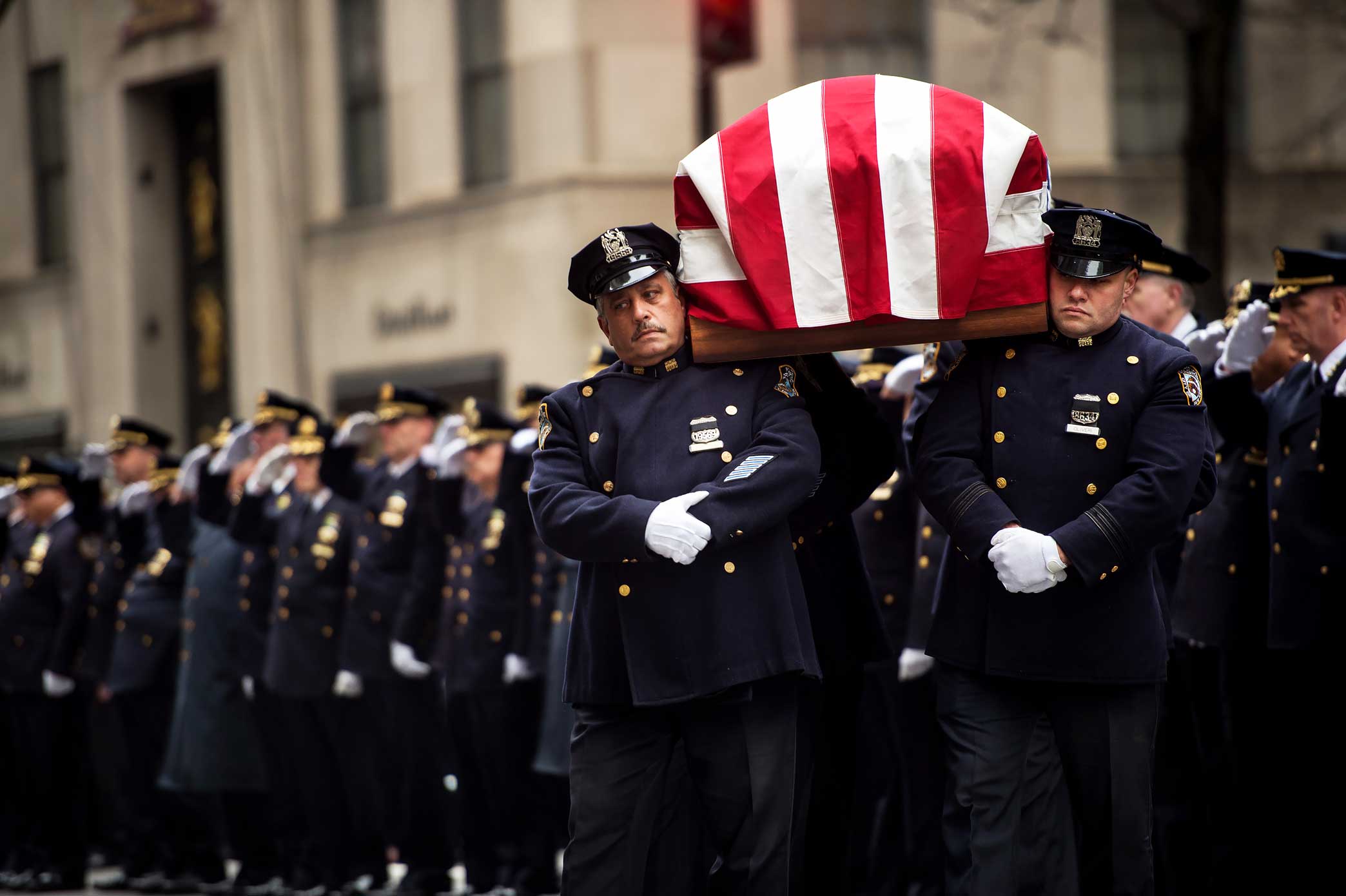NYPD Police Officers carry and salute NYPD Detective Joseph Lemm at St. Patrick’s Cathedral in Manhattan, New York. Detective Lemm was killed by a suicide bomber while serving in the Air National Guard in Afghanistan.