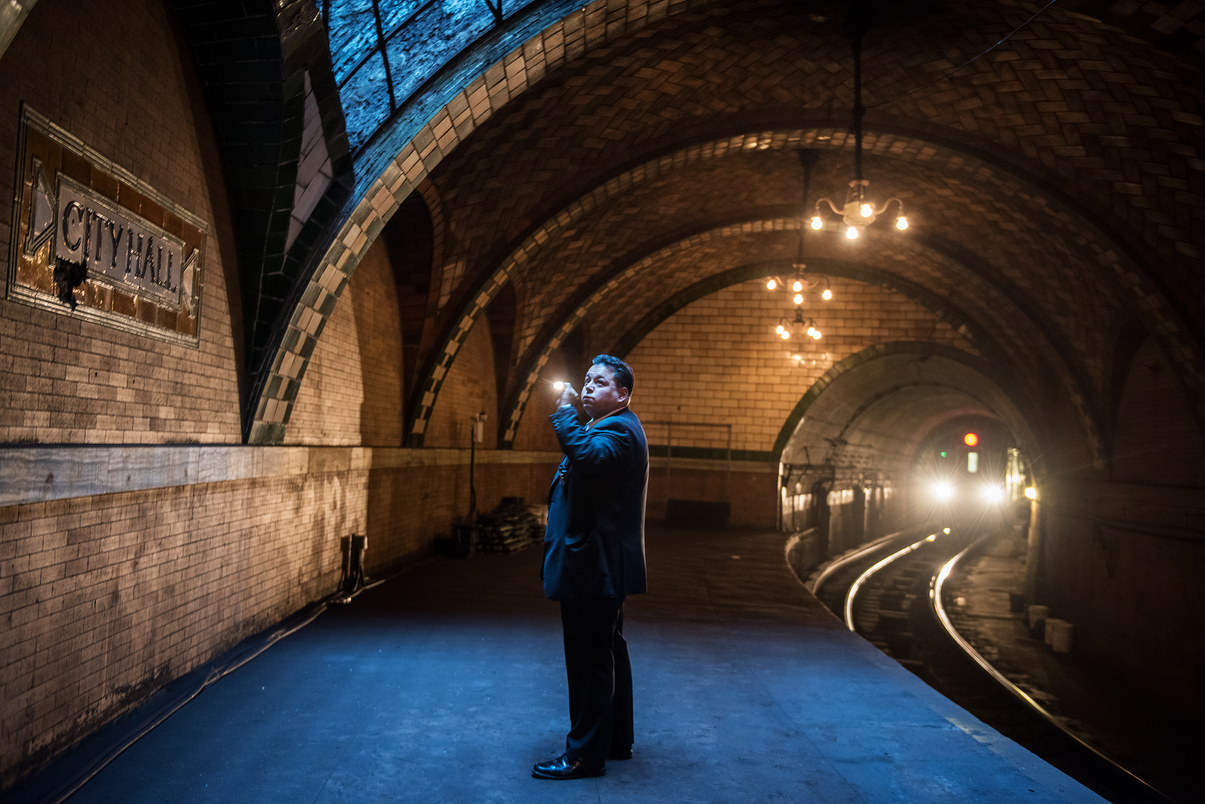  City Hall police officer inspects the inside of the City Hall Subway platform under New York City Hall in Manhattan. The City Hall subway station has been closed for more than 50 years. The 6 train passes through the station once it reaches the end 