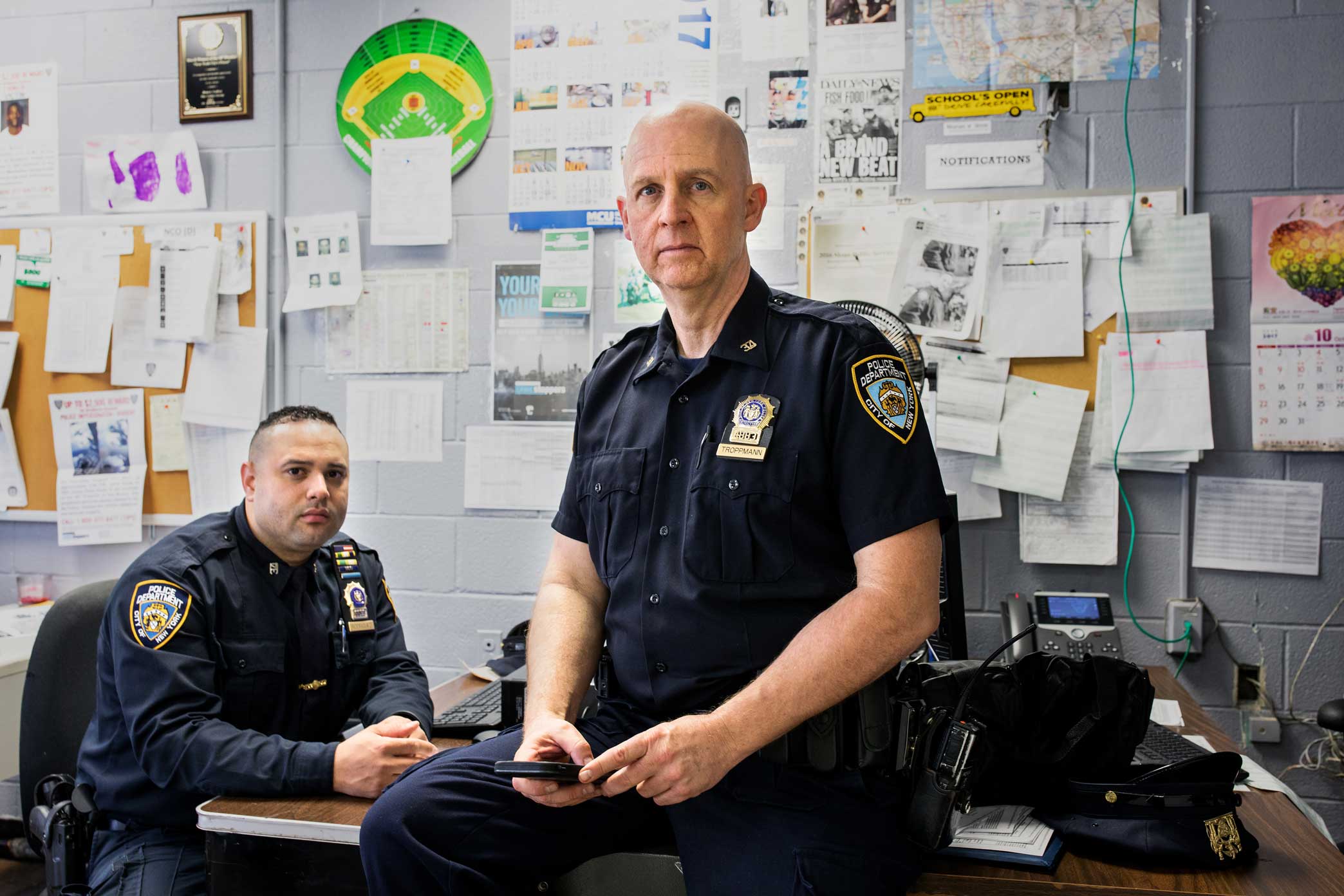 Detective Specialist Thomas W. Troppmann, center, and his partner Detective Specialist Edwin A. Rodriguez at the 34th Precinct in Upper Manhattan.Rodriguez and Troppmann are Neighborhood Coordinating Officers in the precinct who interact directly with the surrounding community in order to improve police and community relations to reduce crime. Story link here .