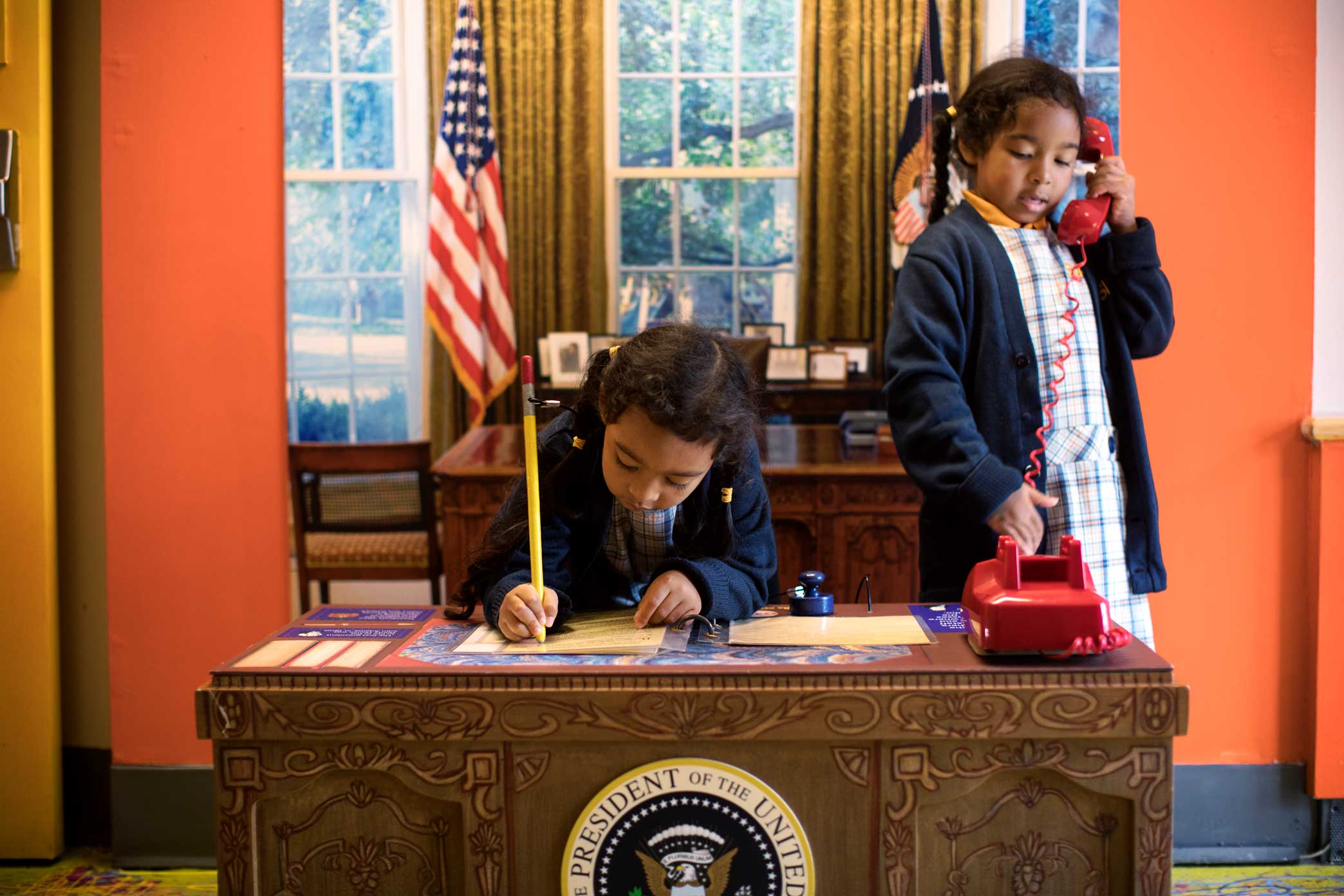 Young kids play at the Presidential Oval Office space at the Manhattan Children Museum in Manhattan, New York.
