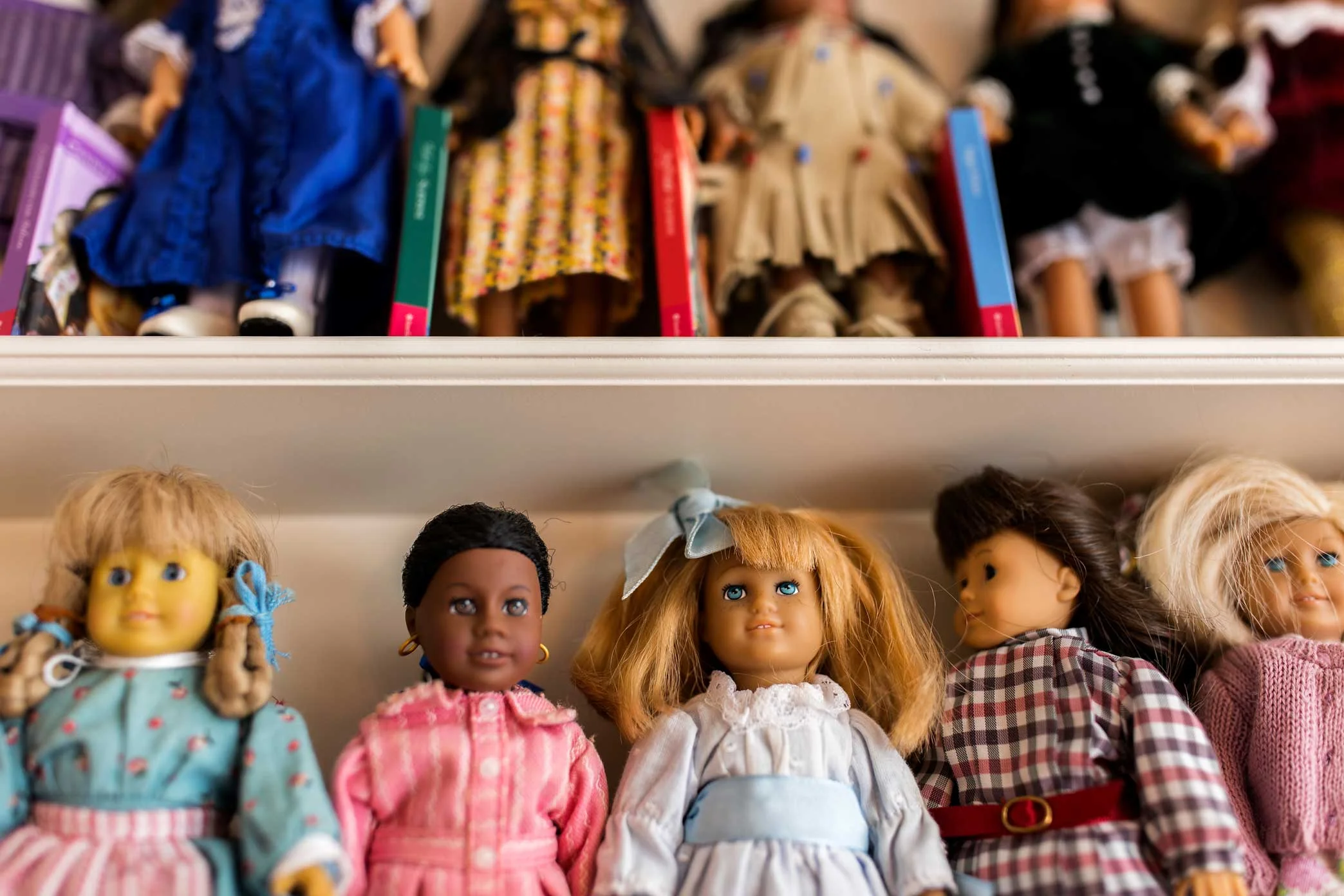 Collection of dolls arranged on the shelves at the resale boutique for American Girl Dolls store Girl A Gain in White Plains, New York.