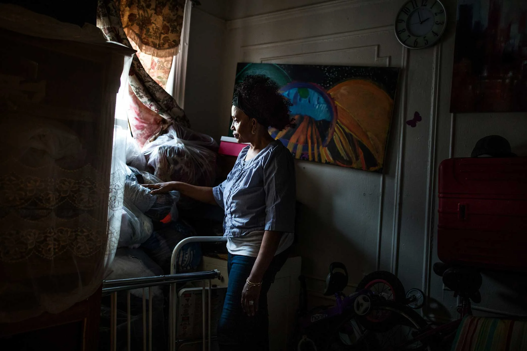 Lorna Vassell goes through her son Saheed’s room at the family home in Crown Heights, Brooklyn.