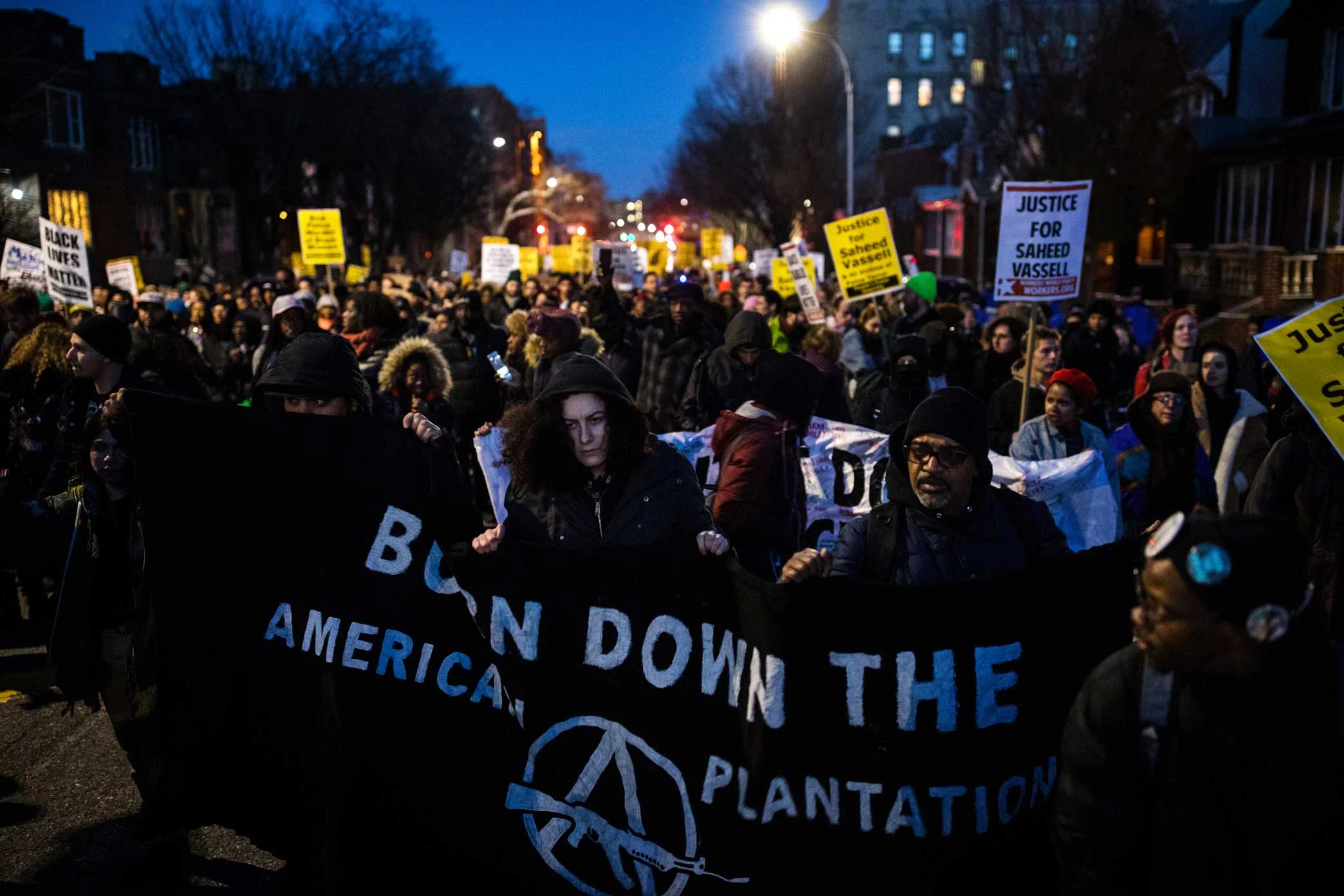Protesters march in the street to the New York City Police Department - 71st Precinct in Brooklyn.