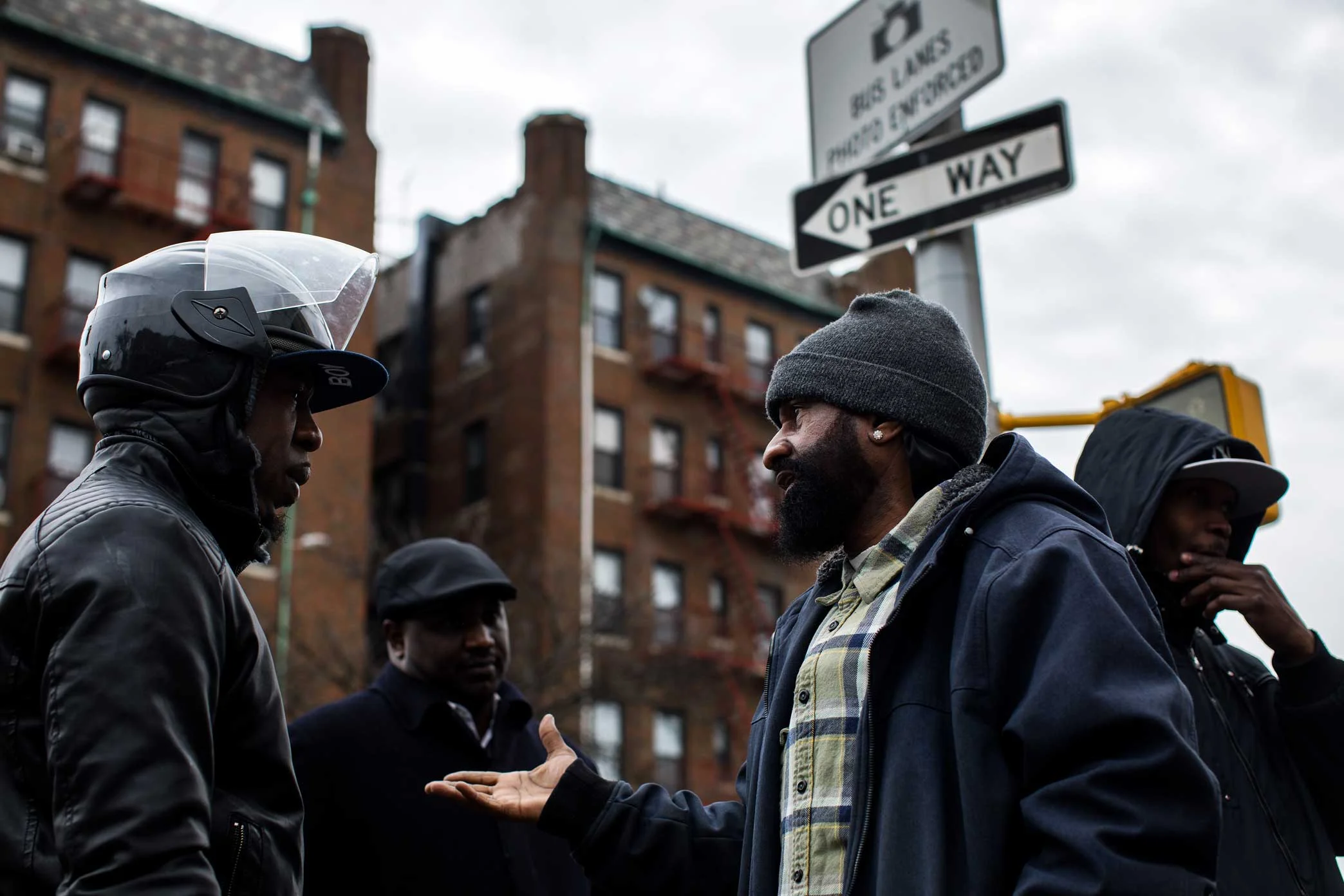 Micheal Thomas, middle, discuss with community member the problems with policing and their training at the memorial site for Saheed Vassell in Crown Heights Brooklyn.