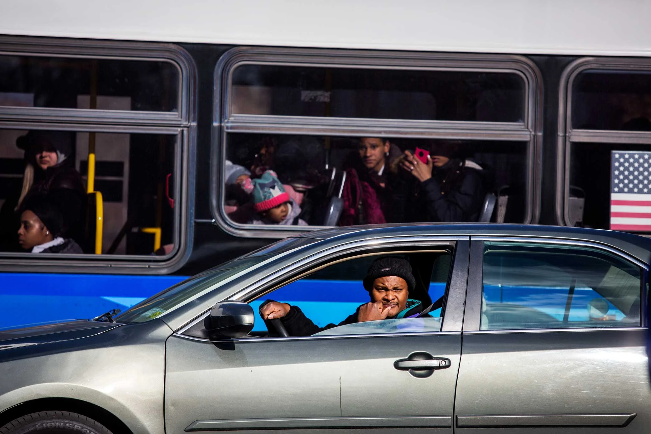 Commuters watch the protesters chant and protest the shooting death of Saheed Vassell.
