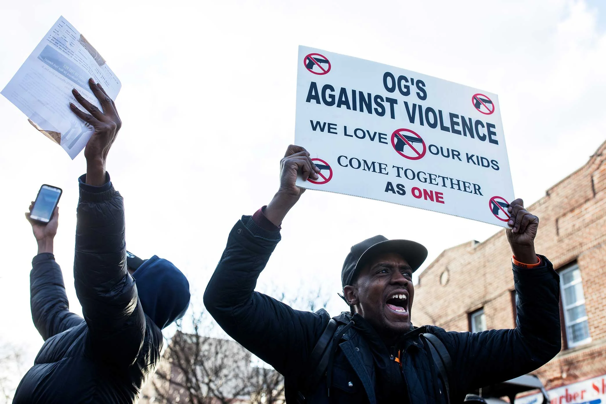Protesters chant in the street stopping traffic on the corner of Utica Ave and Empire Blvd in Brooklyn.