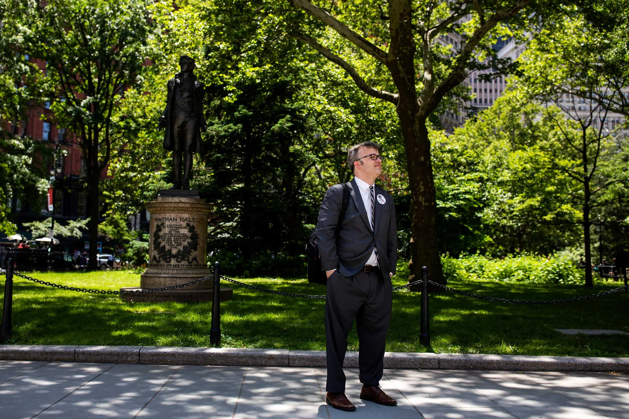 Lead organizer of Manhattan Together, Michael Stanley, waits before a community rally at City Hall.