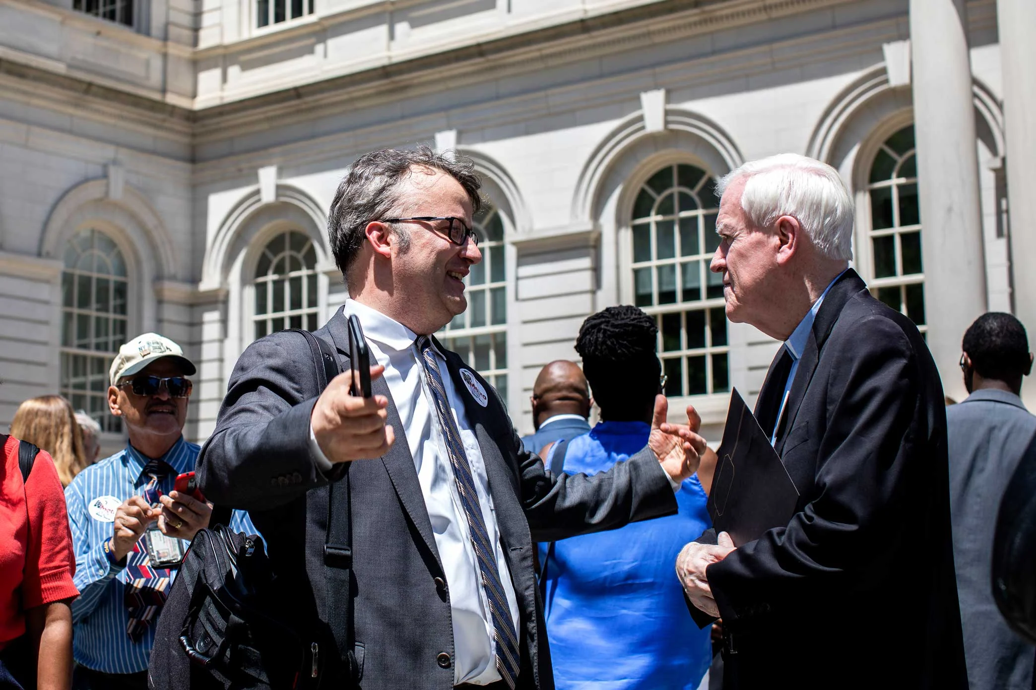 Stanley greets Reverand Francis Skelly, from the Immaculate Conception Church in the South Bronx, after the rally.