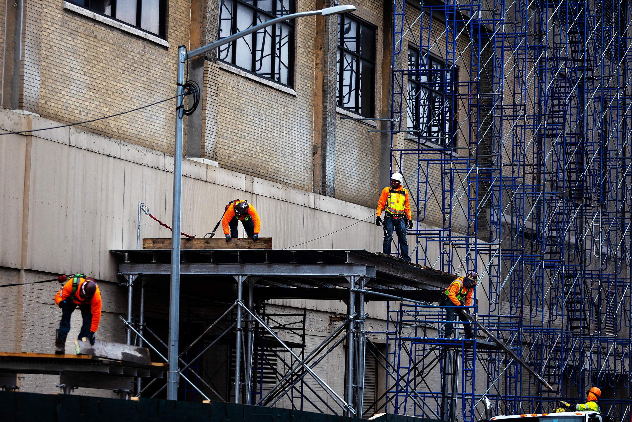 Construction workers putting up scaffold on the outside of the St. John Terminal In Manhattan, New York. Google has confirmed to expand their workforce by 7,000 workers and to add a $1 billion campus in New York City.