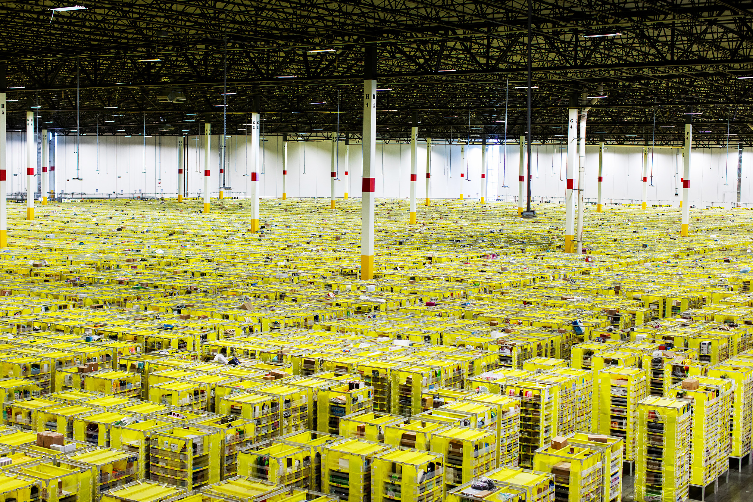  Shelves with product are organized and moved around by Amazon robots inside of the Amazon Fulfillment Center in Carteret, NJ. Workers sort products in different bins, box them and send them out for delivery. 