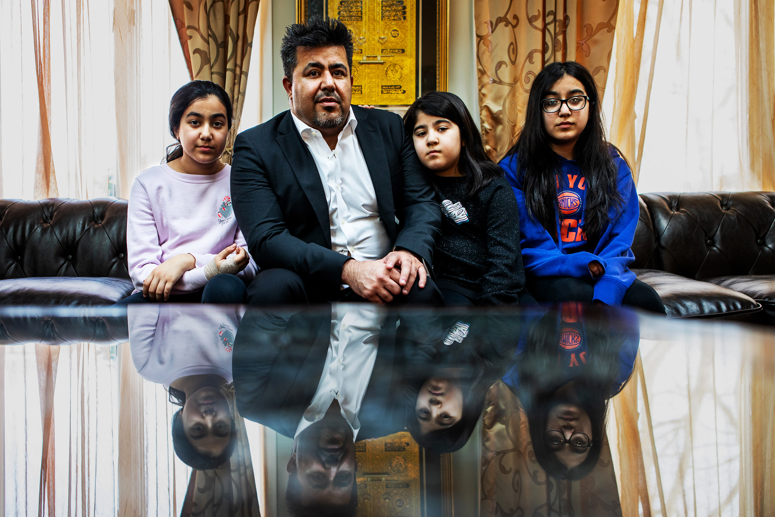  Wali Omarkheil with his children at his home in Commack, New York. Wali was discriminated against because of his religion and was eventually fired. He is now suing the corporation that fired him. 